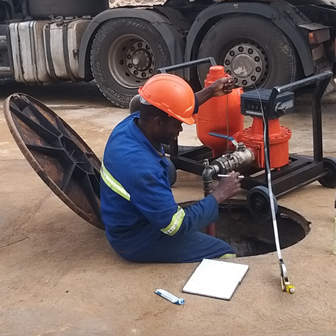 Technician Calibrating Underground Tank